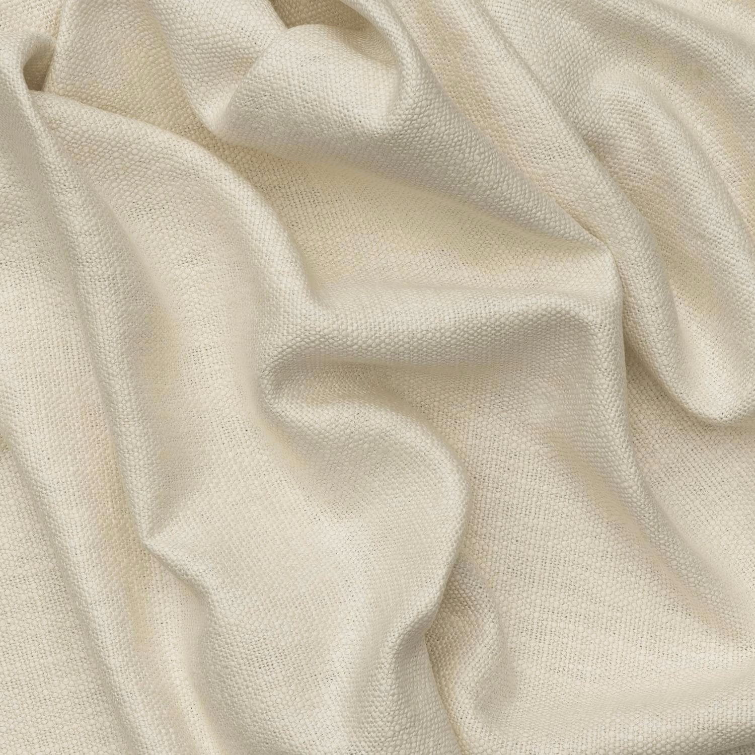 Warm ivory plain weave fabric gathered into softly shadowed sculptural folds