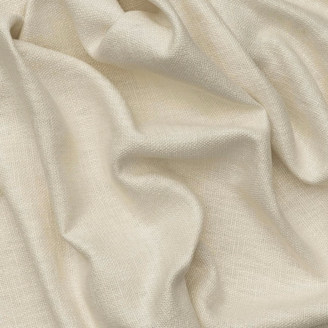 Warm ivory plain weave fabric gathered into softly shadowed sculptural folds
