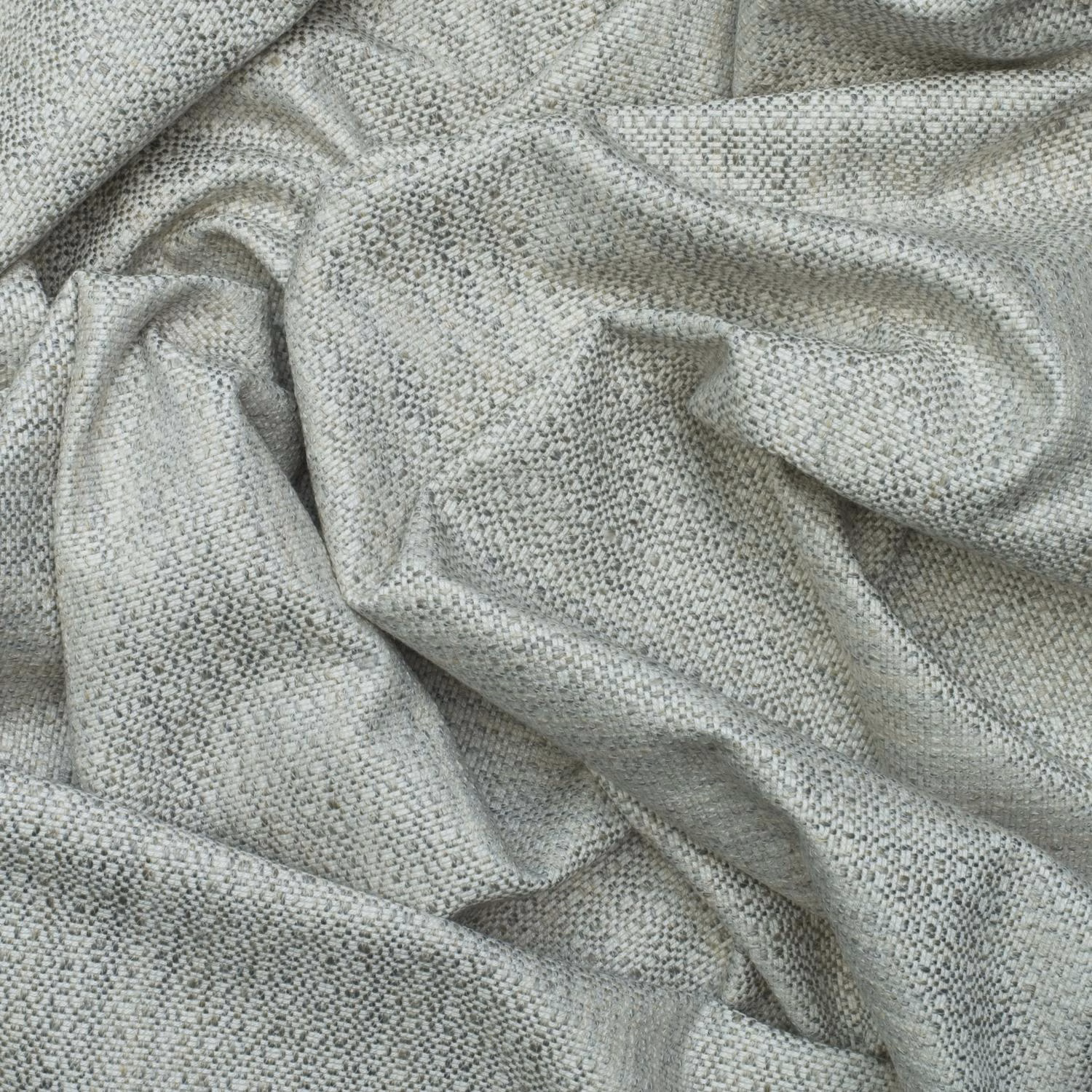 Soft grey fabric with fine dark flecks and a small-scale woven texture