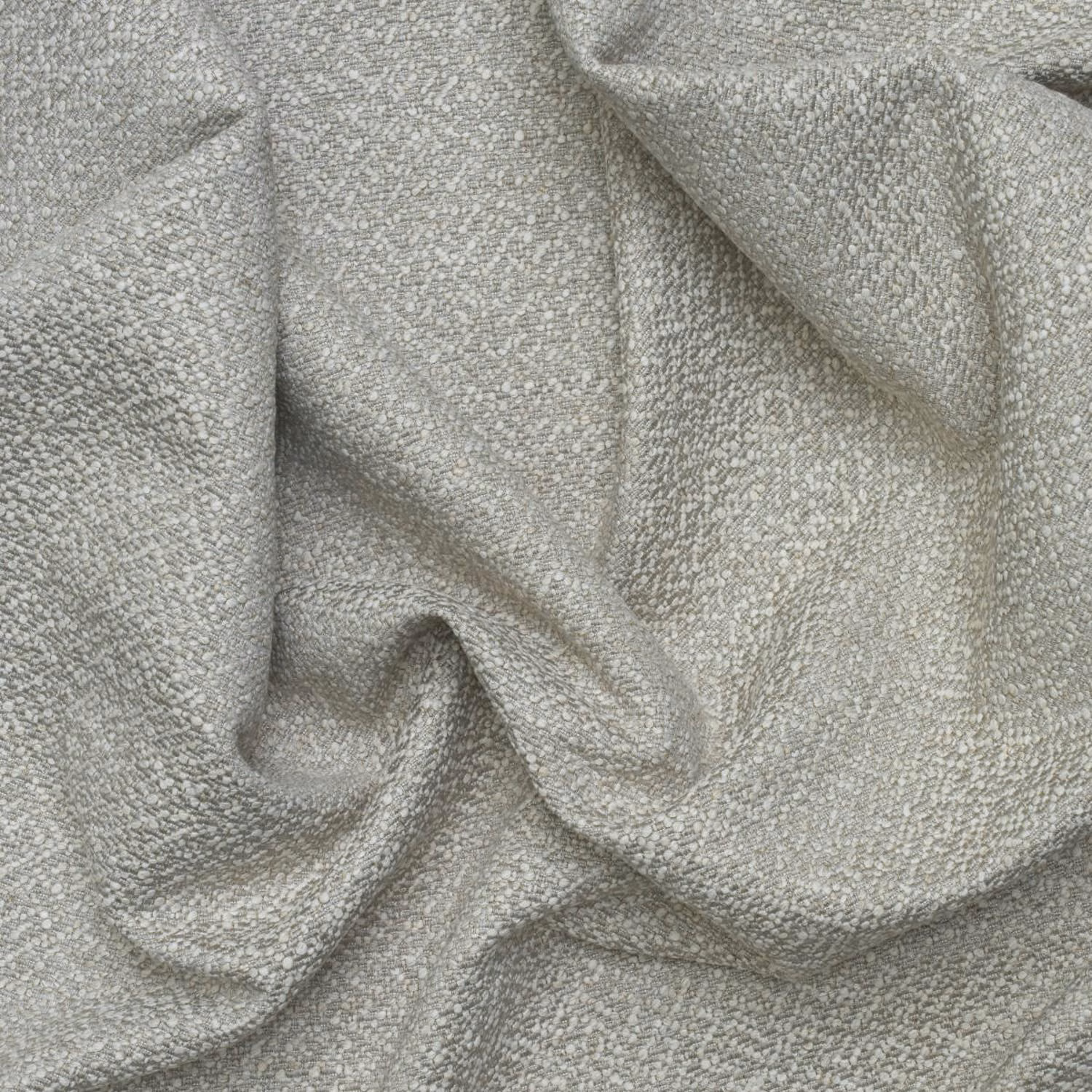 Pale grey-green fabric with fine flecked weave draped in softly shaded folds