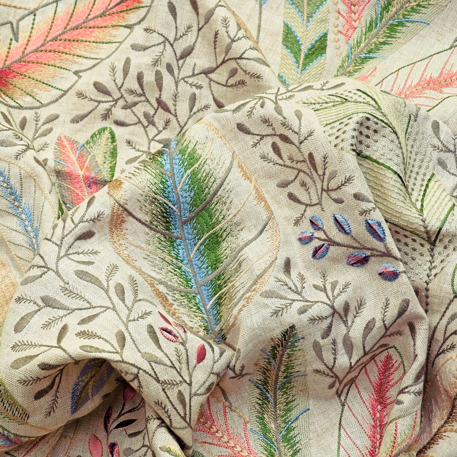 Pale ivory botanical textile with pink, green and blue embroidered feather motifs