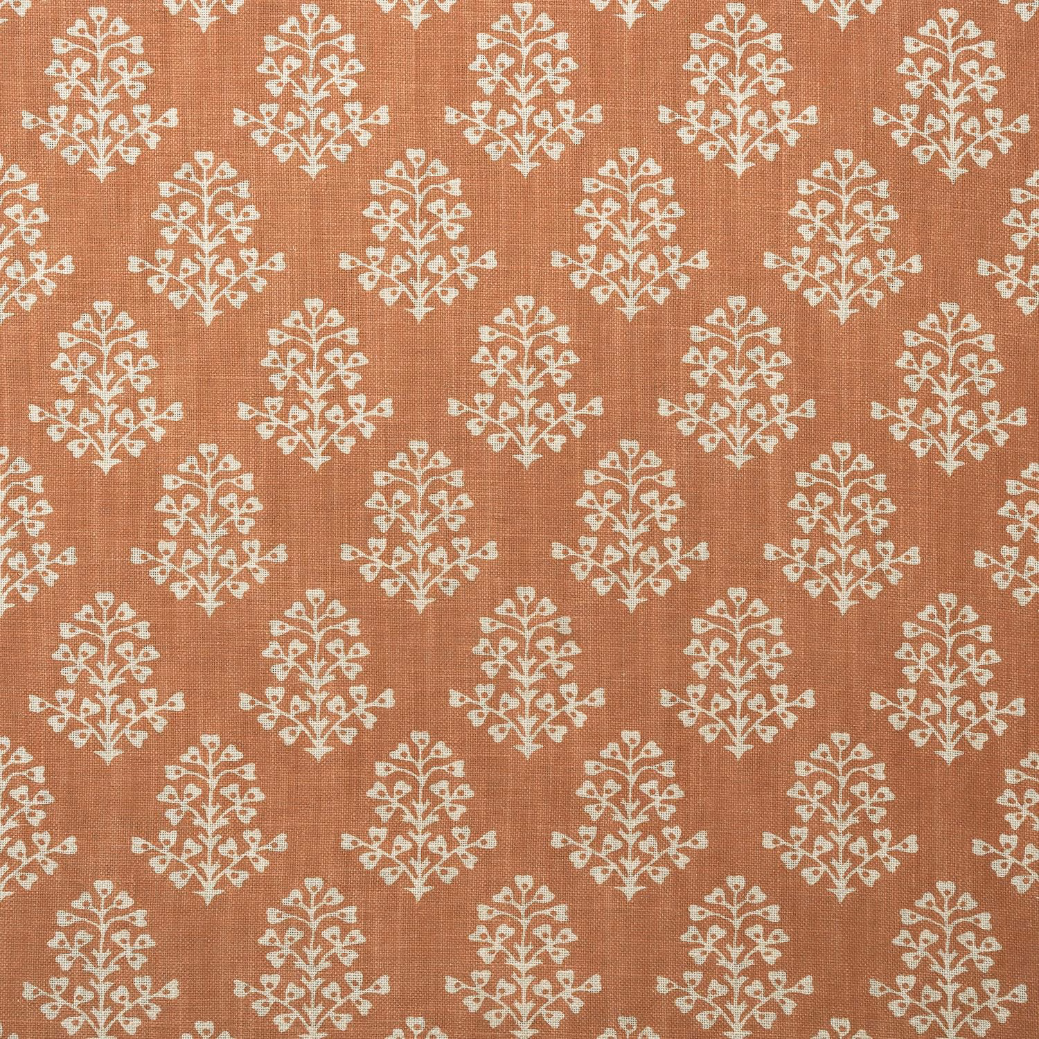Terracotta textile with repeating cream botanical sprigs and a fine woven texture