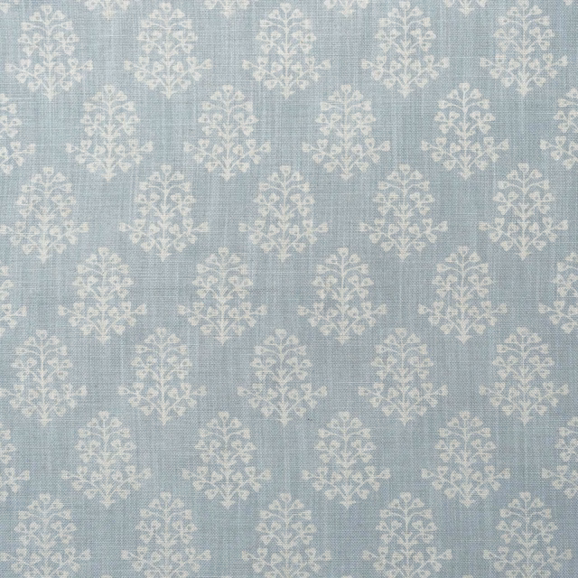 Pale sky-blue woven fabric with repeated chalky ivory botanical sprig motifs