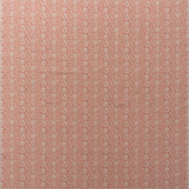 Warm coral-pink cotton print with dense cream paisley motifs in a fine repeat