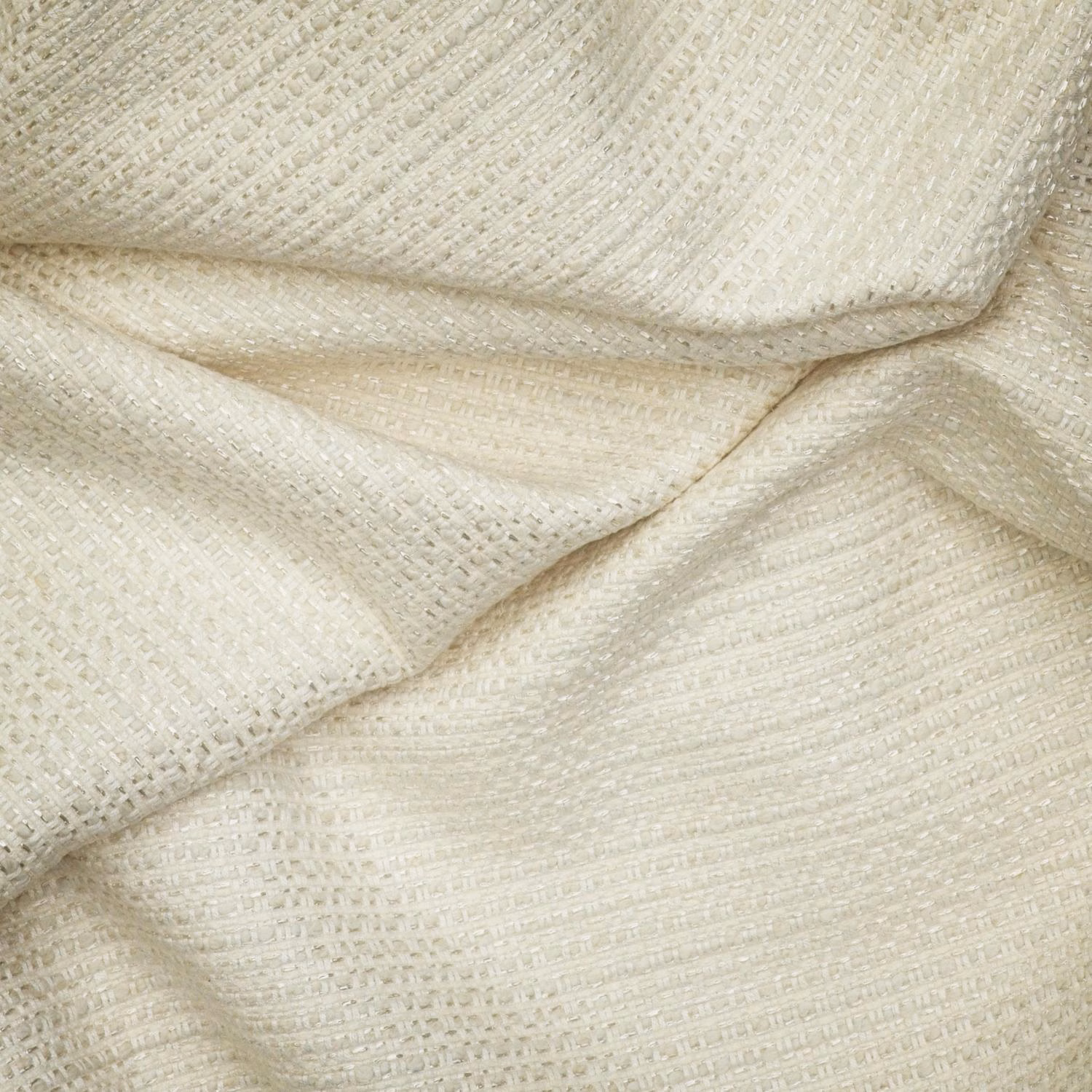 Warm chalk off-white fabric showing a fine, softly ridged woven texture in folded layers
