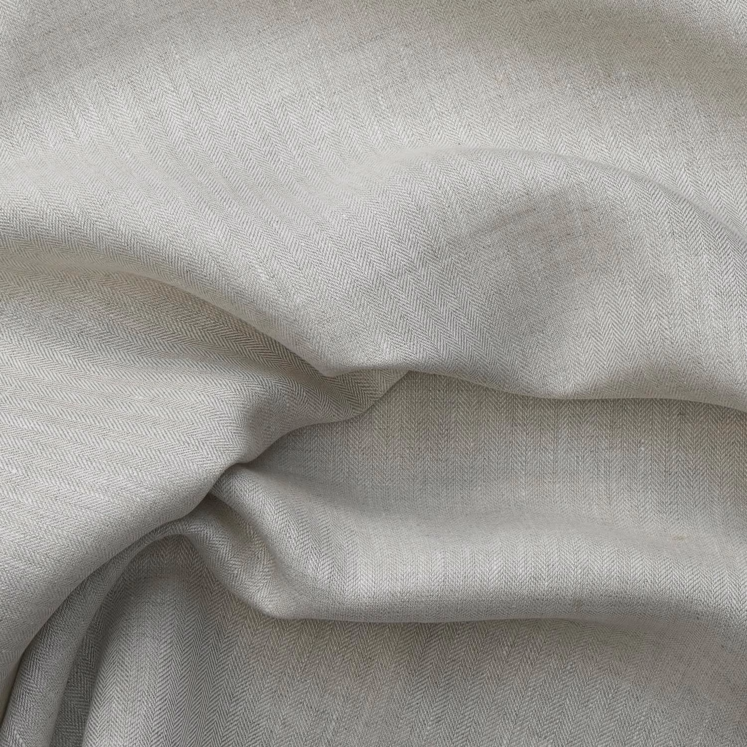 Pale natural beige cloth with fine herringbone weave gathered into soft fluid folds