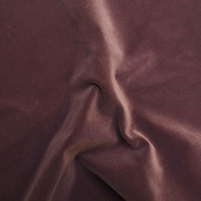 Deep fig-plum fabric with smooth lustre forming softly gathered, fluid folds
