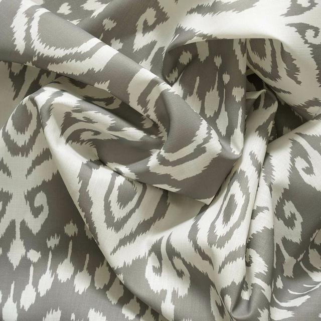 Stone-grey and ivory outdoor fabric with a bold, irregular ikat motif