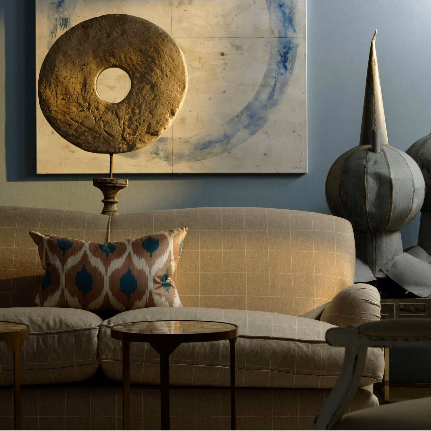 Warm camel-beige fabric with fine woven grid on a rounded upholstered sofa