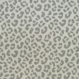 Cool grey leopard spots scattered across a softly textured cream woven ground