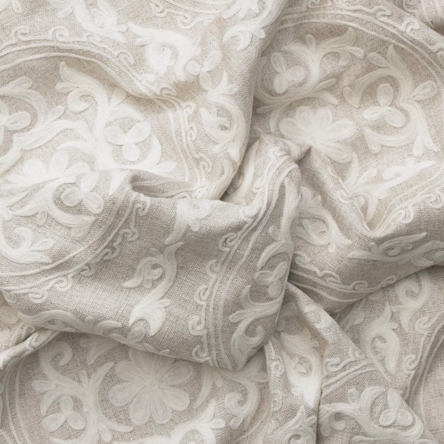 Ivory woven fabric with raised scrolling paisley and floral motifs in soft taupe