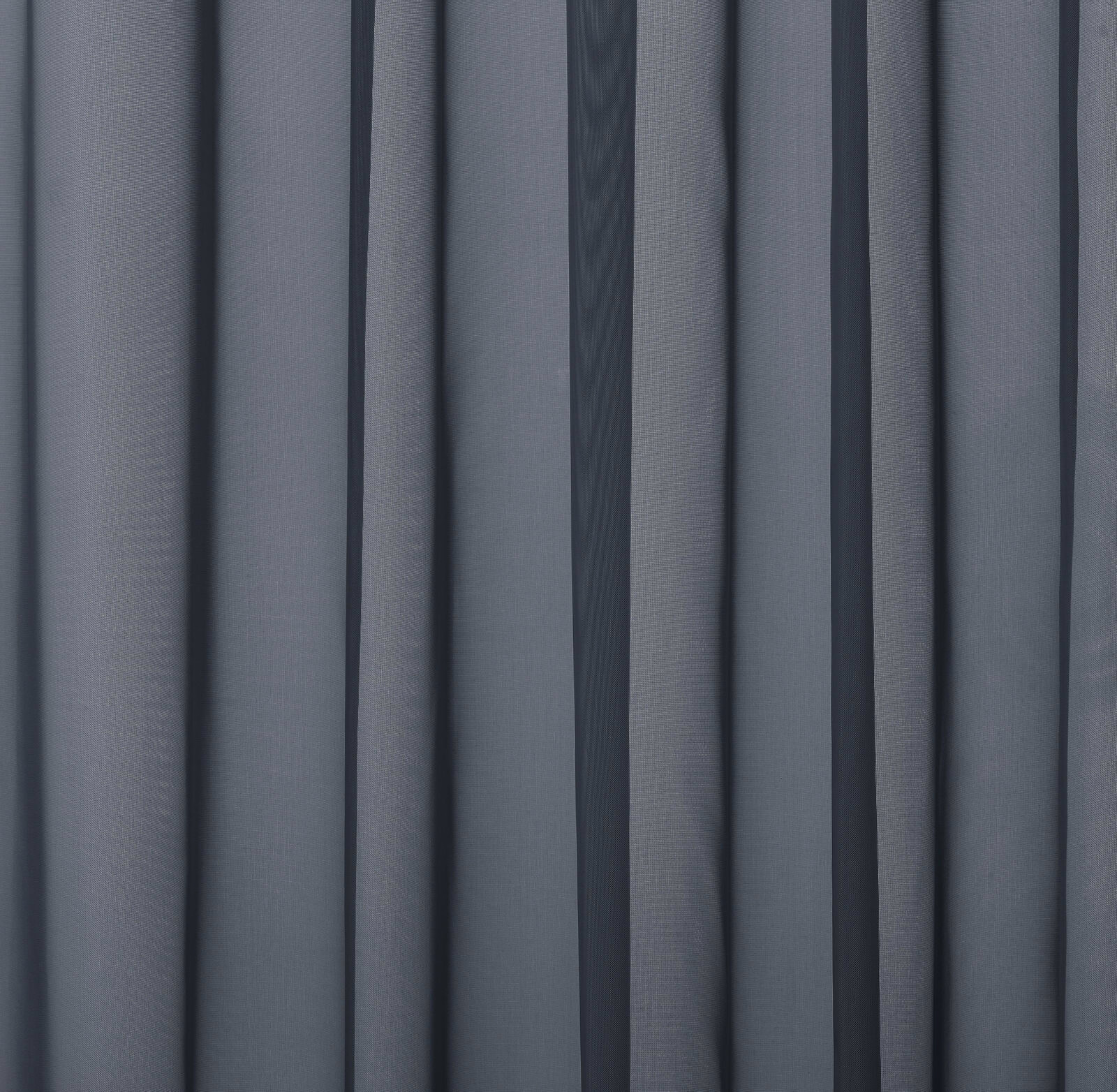 Close-up of cool blue-grey plain curtain fabric with soft folded drape