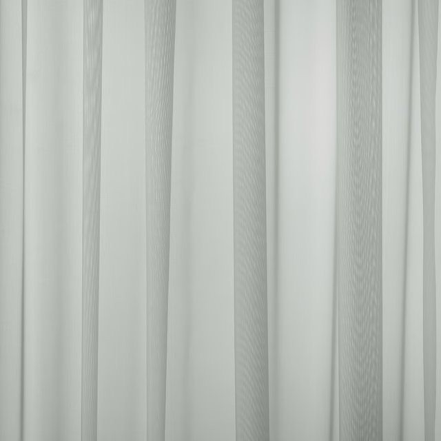 Pale dove grey sheer fabric with fine vertical texture and soft drape