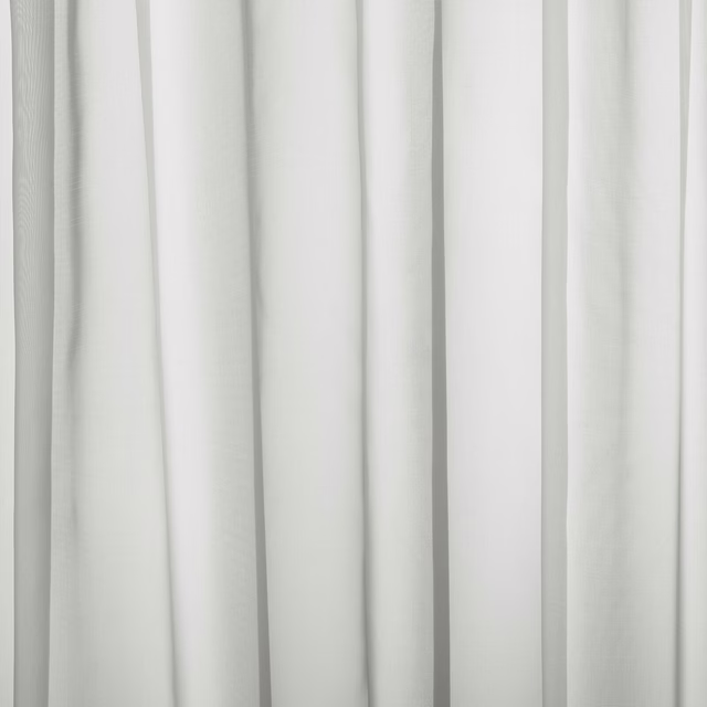 Soft ivory plain curtain fabric with gentle vertical folds