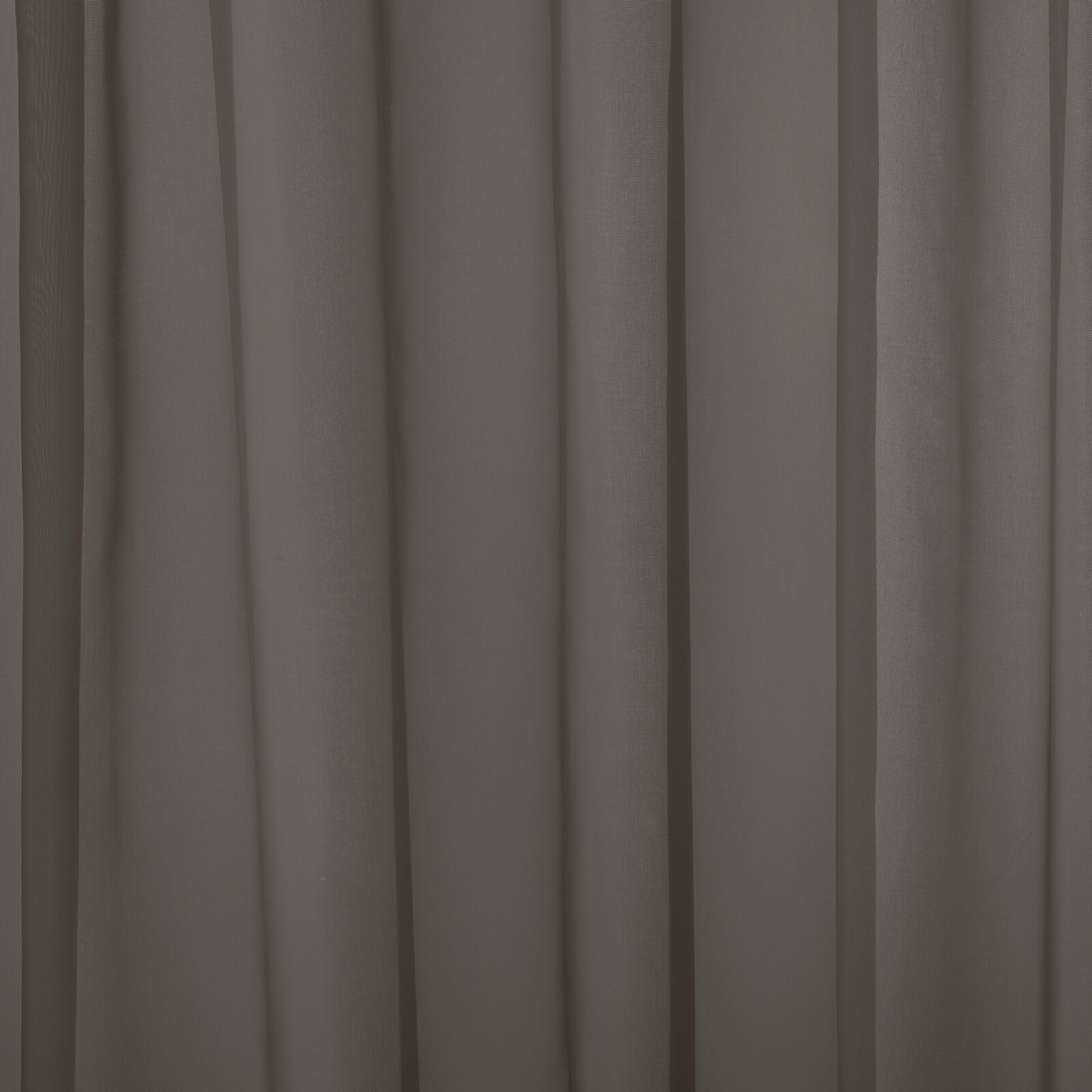 Muted mole taupe plain curtain fabric hanging in soft vertical folds