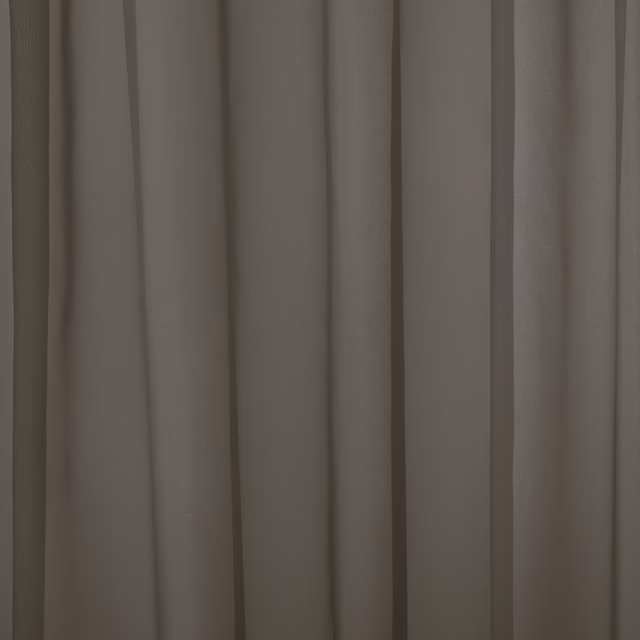 Muted mole taupe plain curtain fabric hanging in soft vertical folds