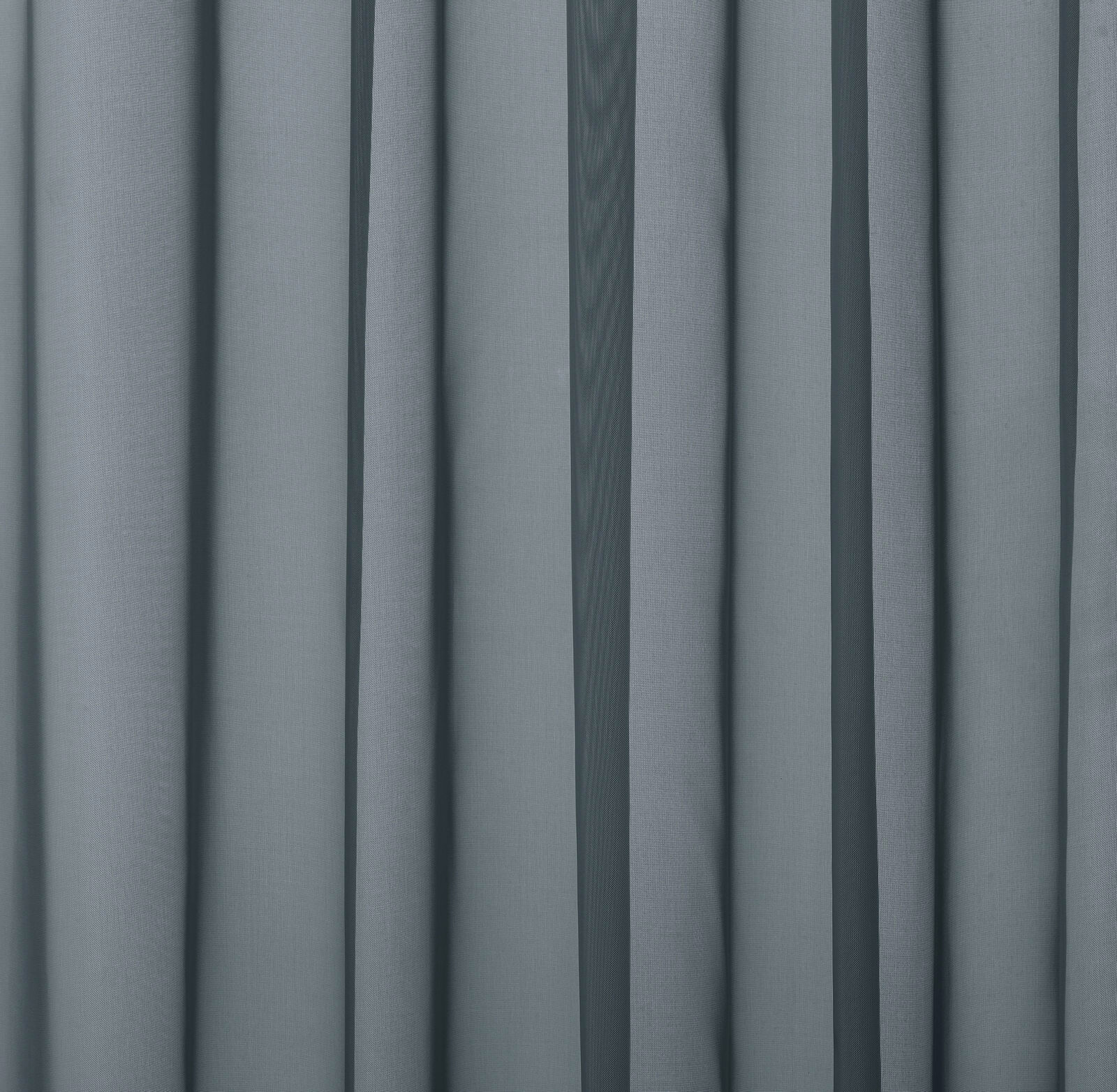 Soft slate-blue plain curtain fabric with gentle vertical folds and a smooth weave