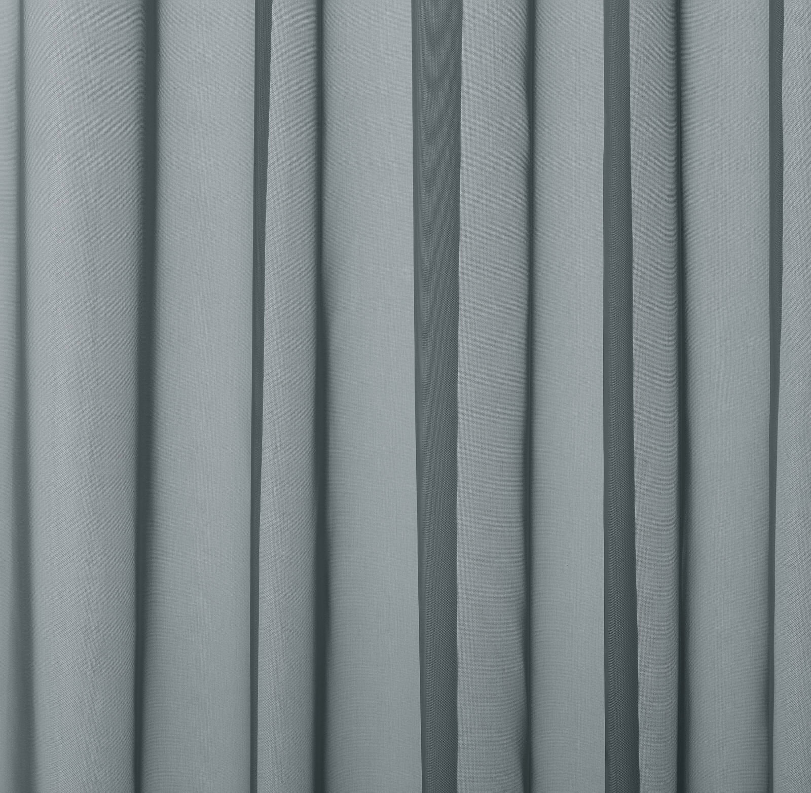 Soft muted blue plain fabric with smooth vertical folds and matte finish
