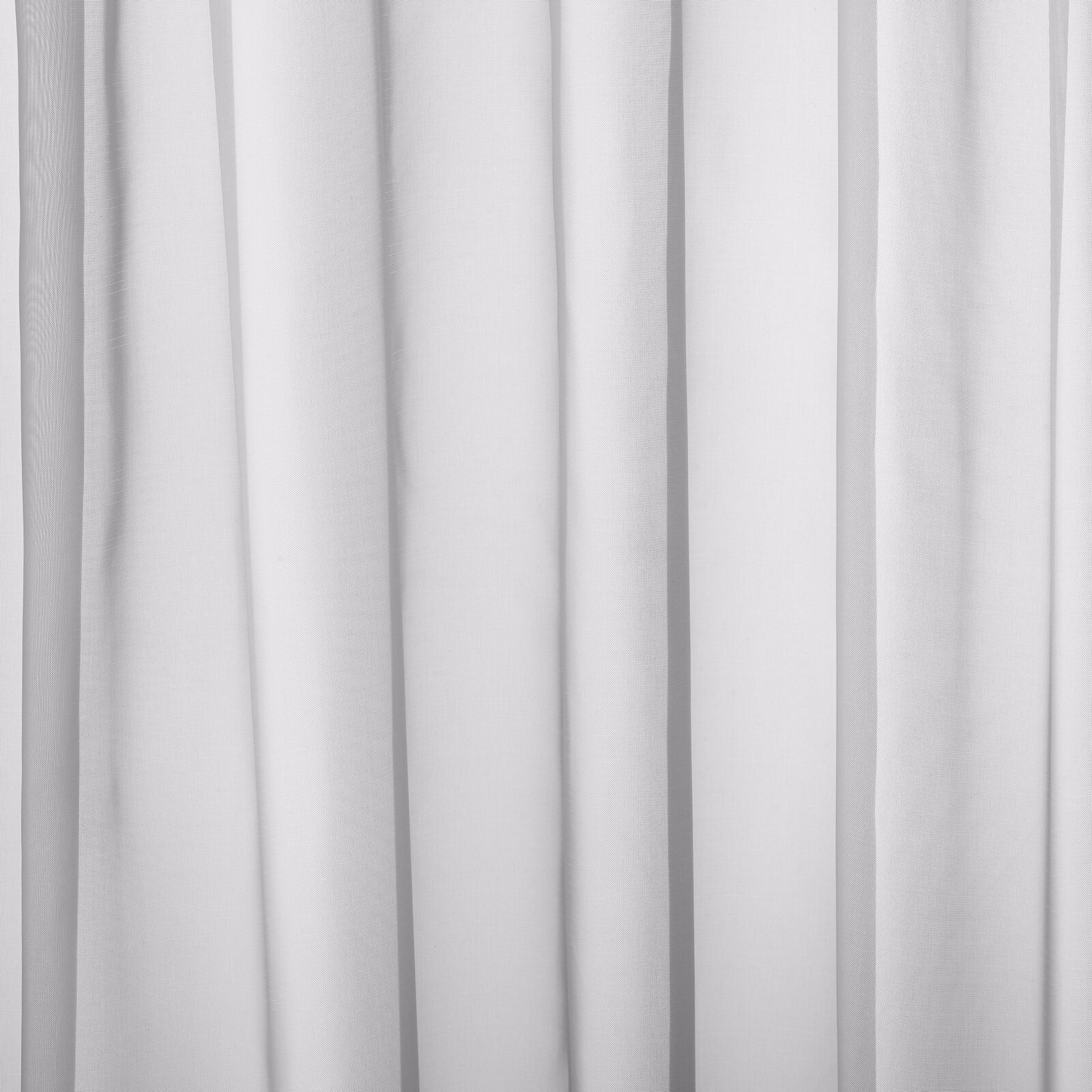 Soft icy white plain curtain fabric shown in gentle vertical folds