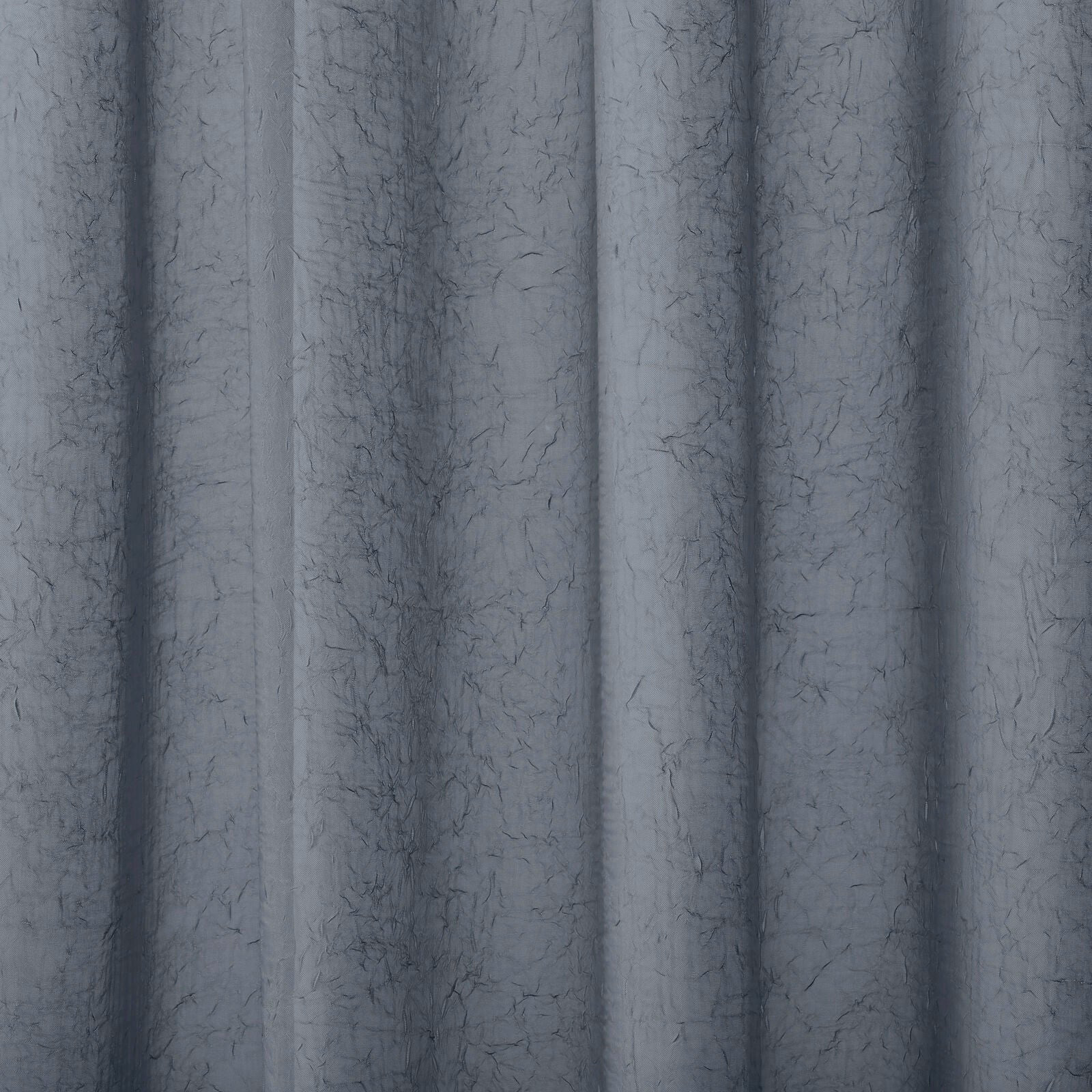 Soft denim-blue plain fabric with a fine crinkled texture and gentle folds