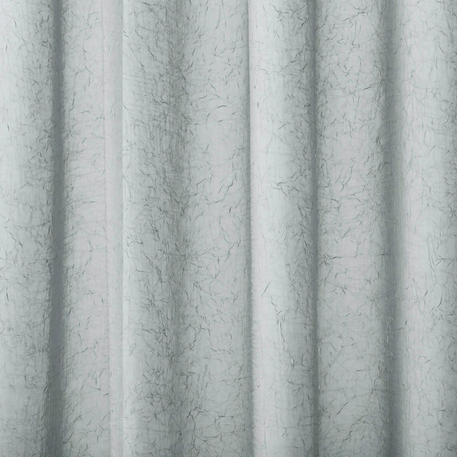 Pale misty grey plain curtain fabric with fine slubbed texture and soft vertical folds