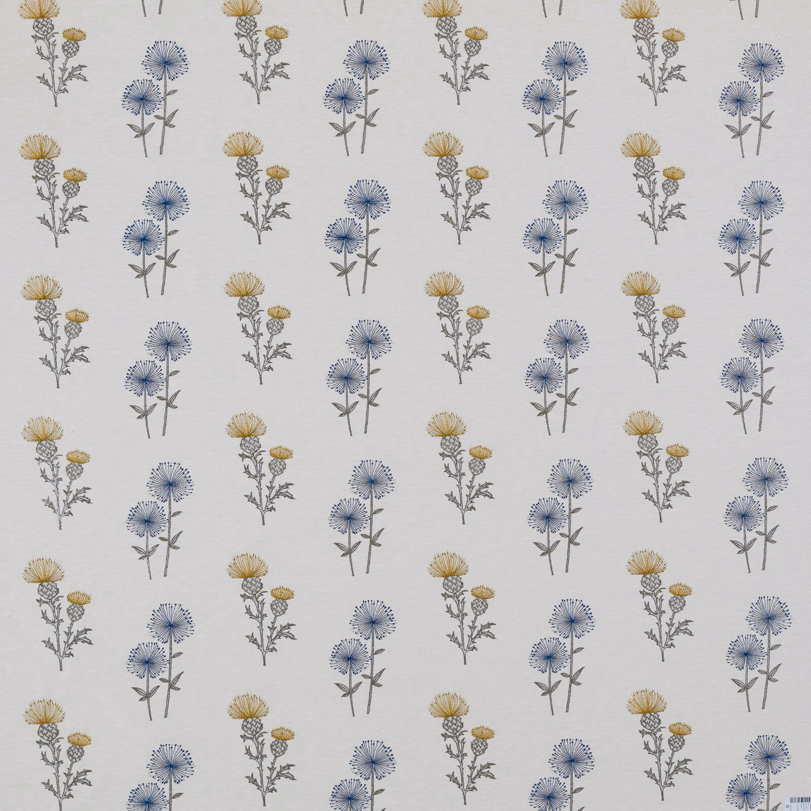 Ivory floral fabric with small blue and yellow botanical sprigs in a neat repeat