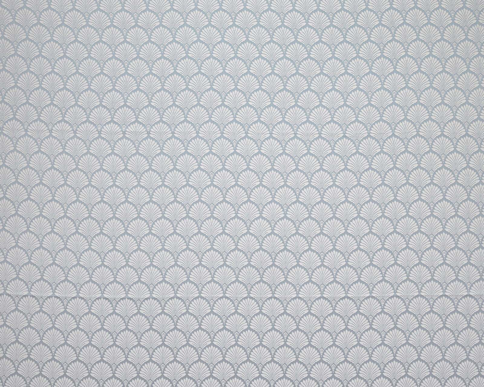 Soft Wedgwood blue fabric with a small repeating fan motif and pale ground
