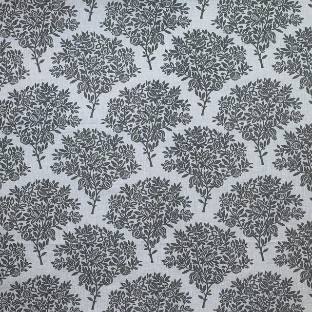 Repeated botanical tree motif in dark blue-grey on a pale Wedgwood blue fabric