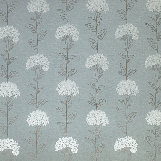 Mineral teal floral drapery fabric with pale clustered blooms and fine leaf stems