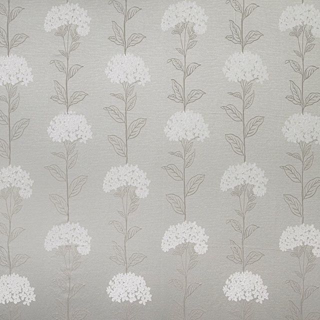 Soft beige floral drapery fabric with pale clustered blooms and fine leaf stems