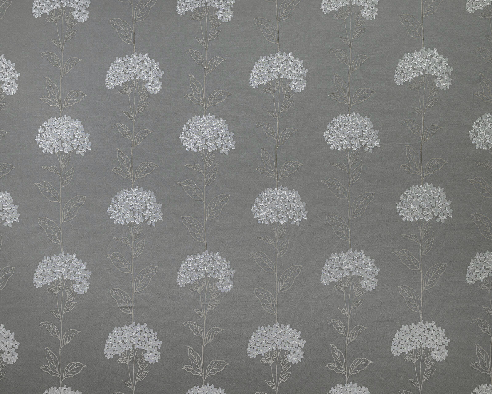 Soft grey botanical fabric with pale floral stems and clustered blooms