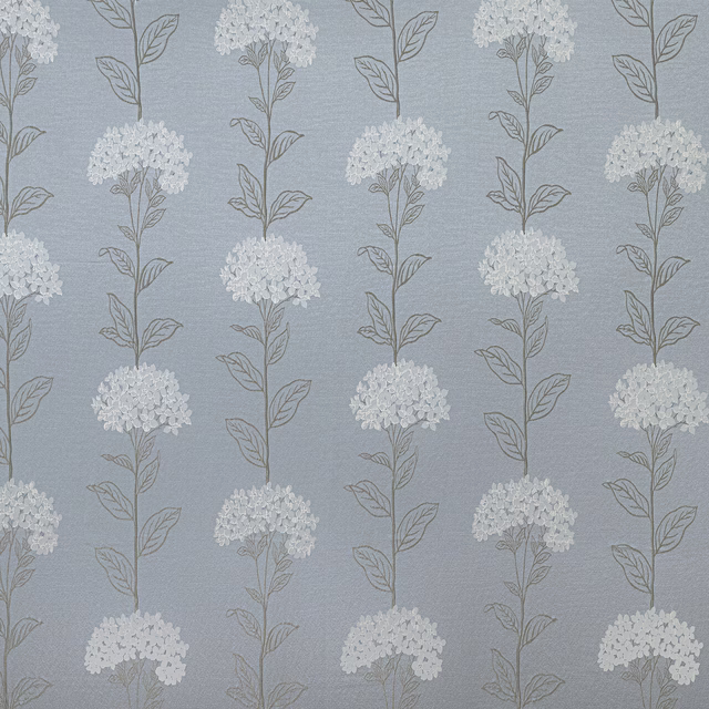 Soft wedgewood blue floral fabric with white blossom clusters and fine leaf outlines