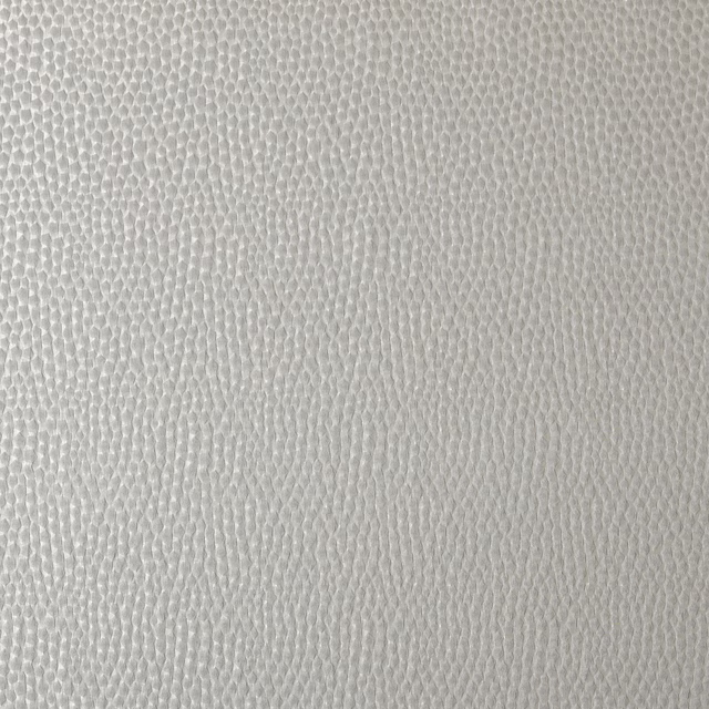 Close-up of pale platinum white textured woven fabric with fine pebble surface