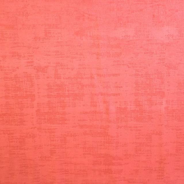 Bright coral pink textured plain fabric with a softly mottled weave