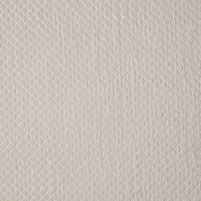 Close-up of soft taupe woven fabric with tiny geometric texture