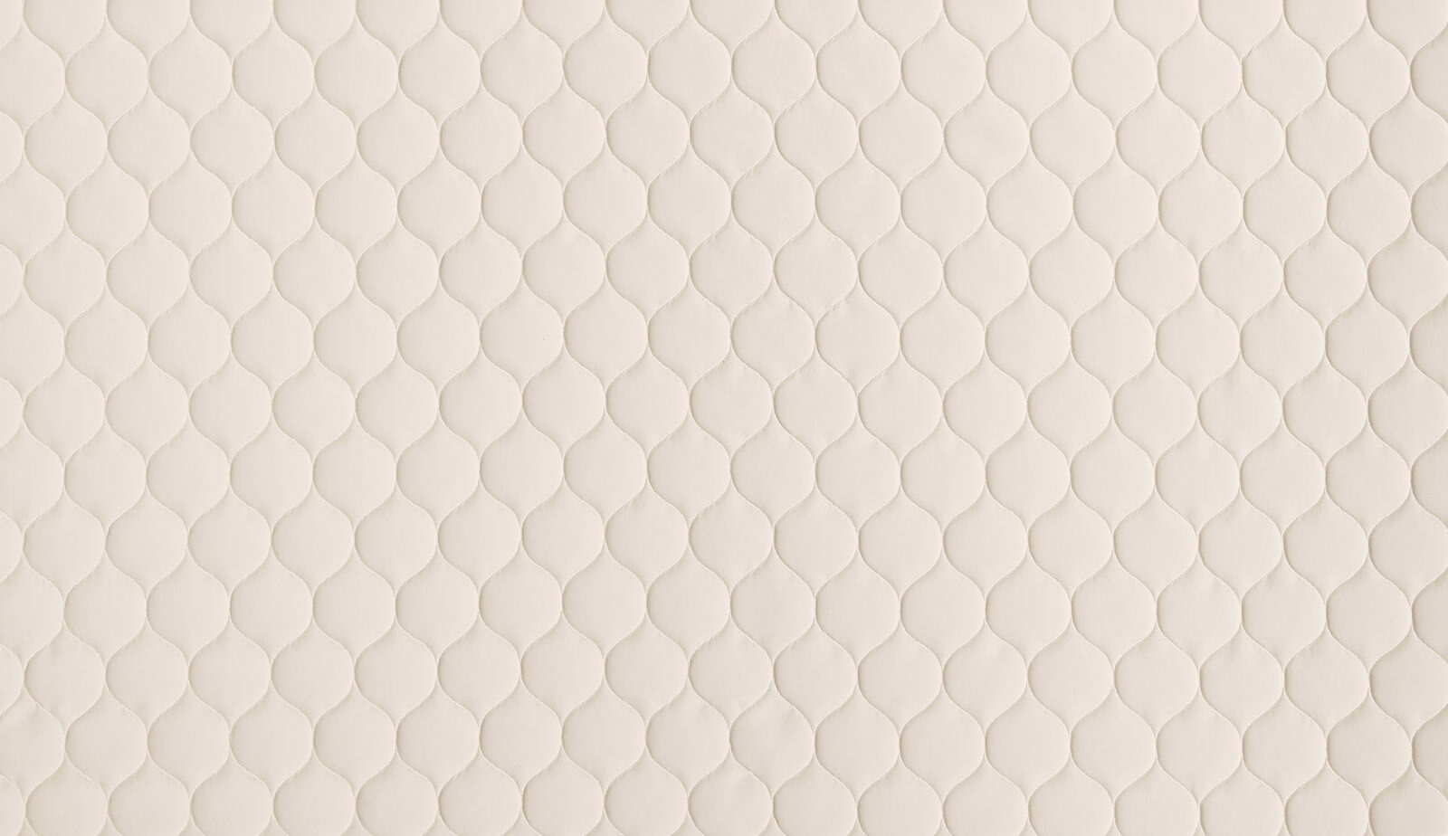 Warm ivory cream fabric with small raised teardrop pattern and soft matte texture