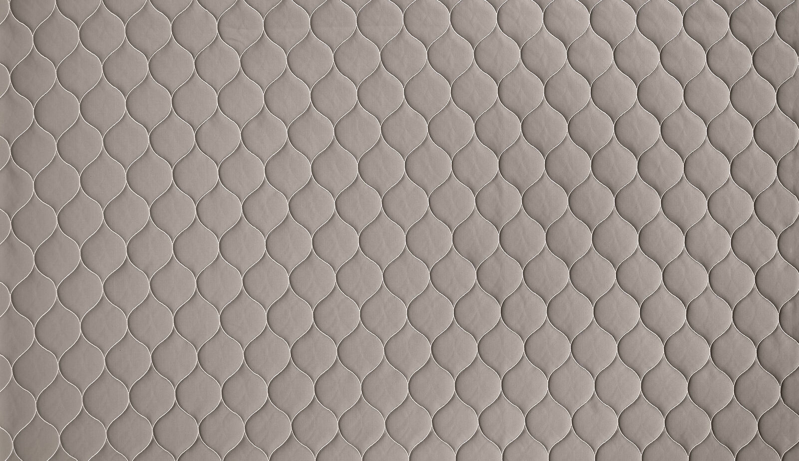 Warm taupe woven fabric with small repeating scalloped outline pattern