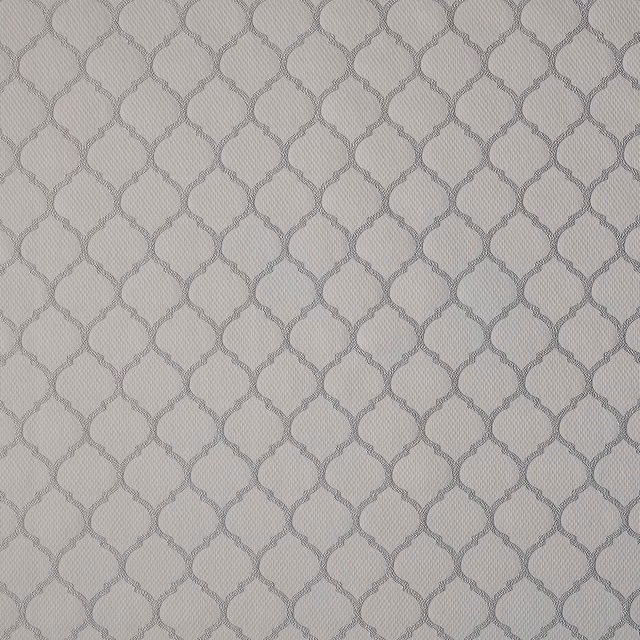 Close-up of warm fawn woven fabric with small geometric pattern