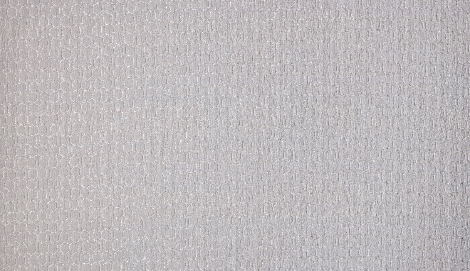 Close-up of pale oyster ivory woven fabric with a fine textured small-scale pattern