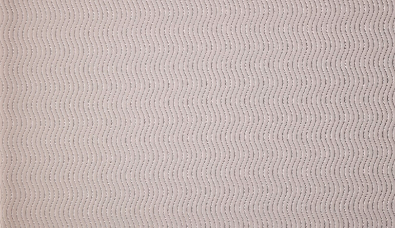Close-up of soft taupe wavy stripe woven fabric with fine linear texture