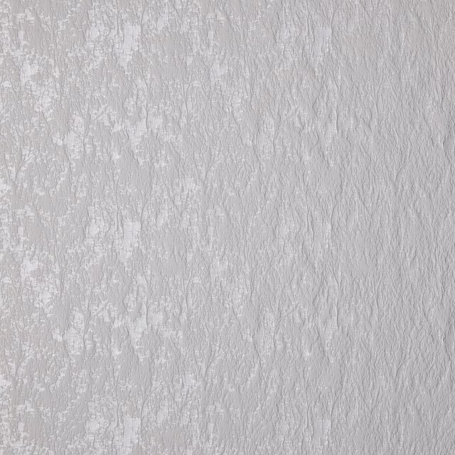 Pale platinum grey textured floral drapery fabric with soft tonal weave