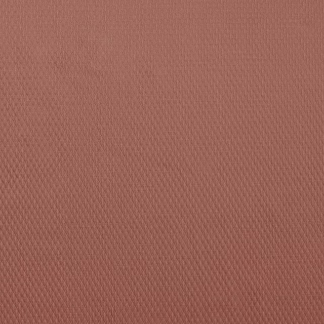 Close-up of a soft coral terracotta woven fabric with fine textured diagonal pattern