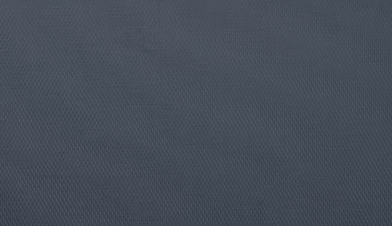 Close-up of a deep indigo woven fabric with fine textured surface