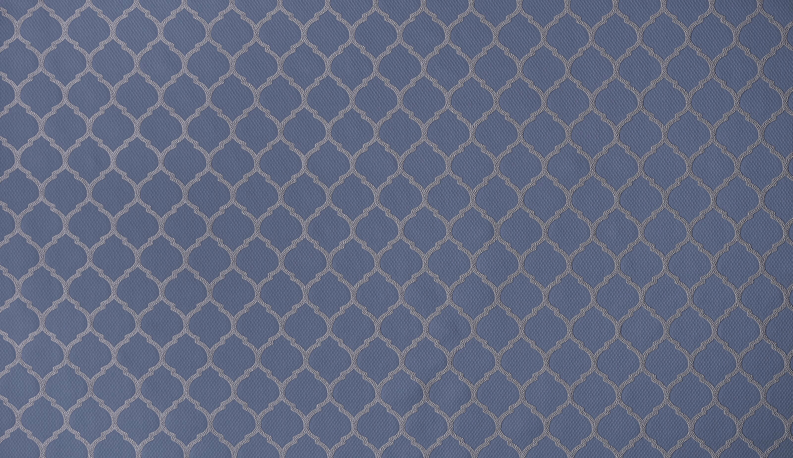 Muted denim blue woven fabric with small linked geometric pattern