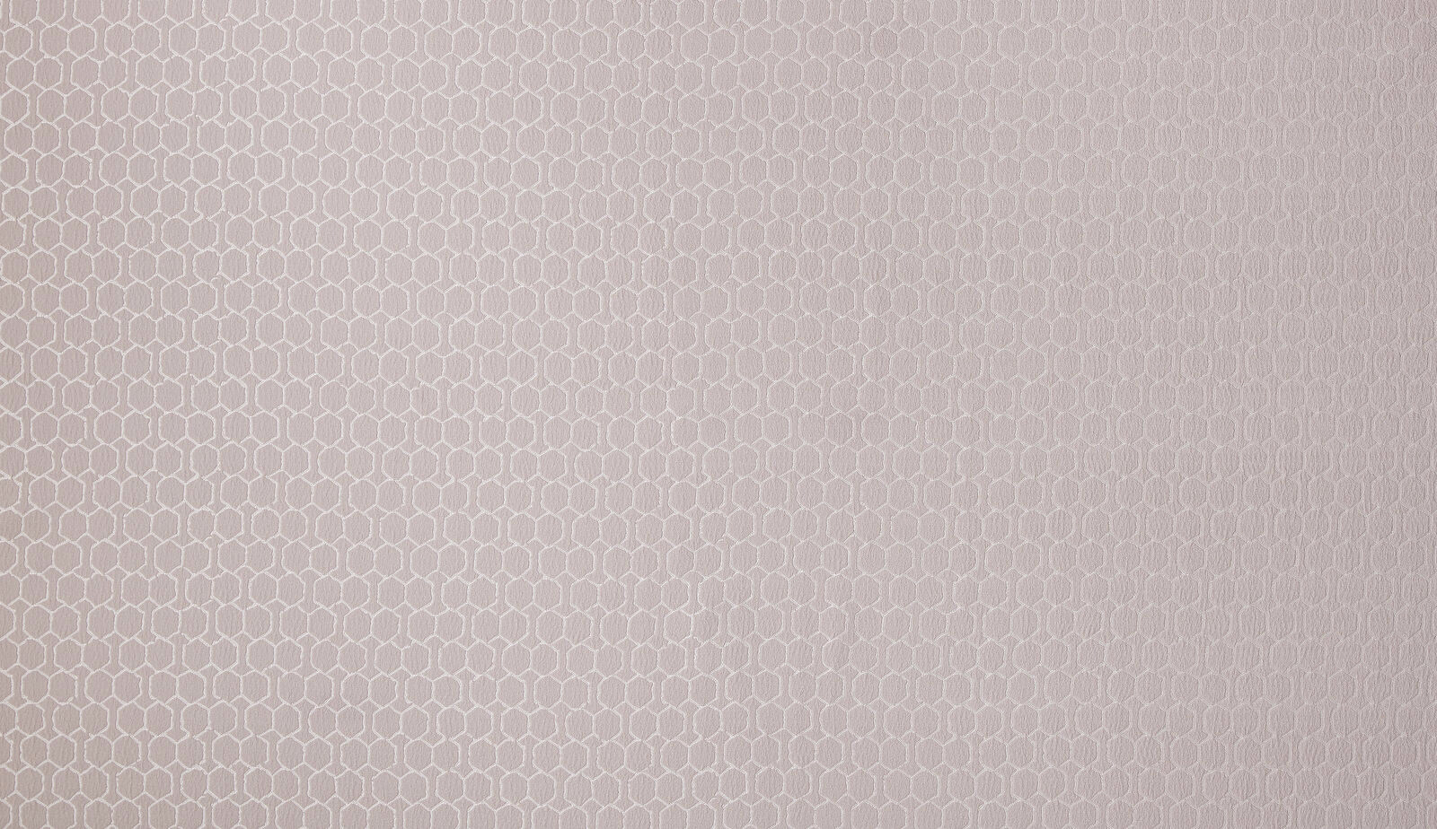 Soft orchid pink geometric woven fabric with a small repeating hexagonal motif