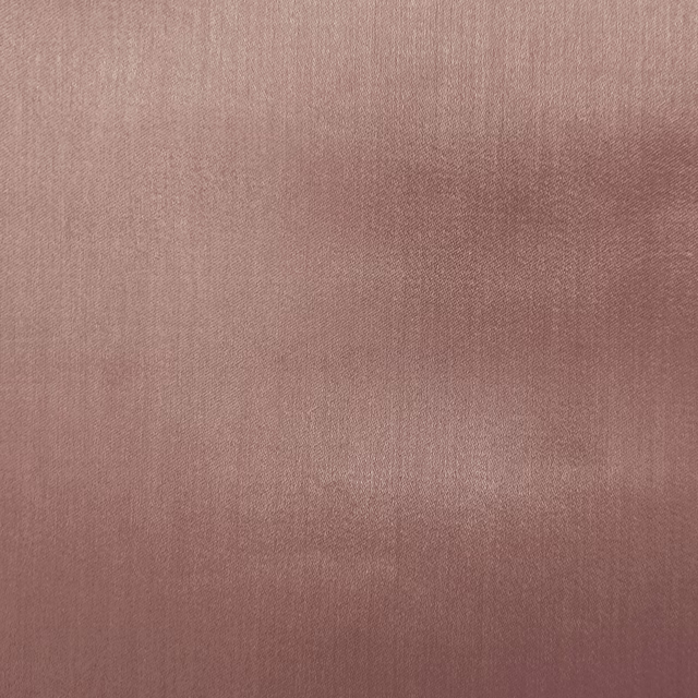 Dusty blush pink plain fabric with a soft satin sheen and smooth weave