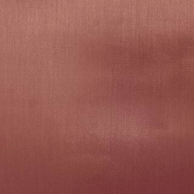 Soft coral terracotta plain fabric with a subtle woven sheen