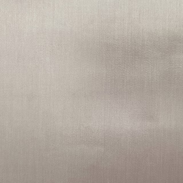 Soft beige plain woven fabric with a subtle matte-sheen finish