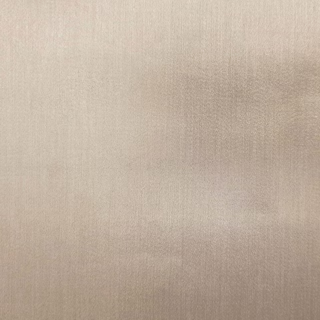 Warm sandy beige plain fabric with a smooth matte weave