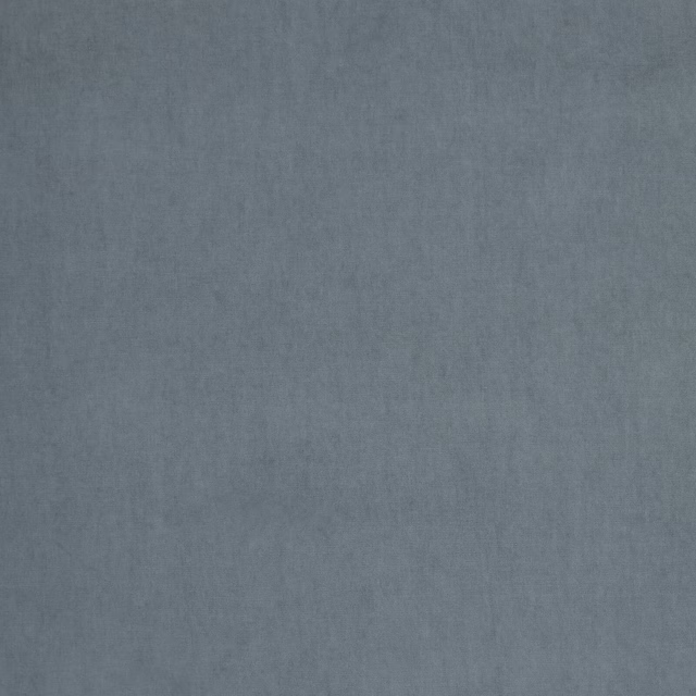 Soft dusty blue-grey plain fabric with a subtly mottled woven texture